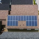 solar panels on tiled roofs of a house